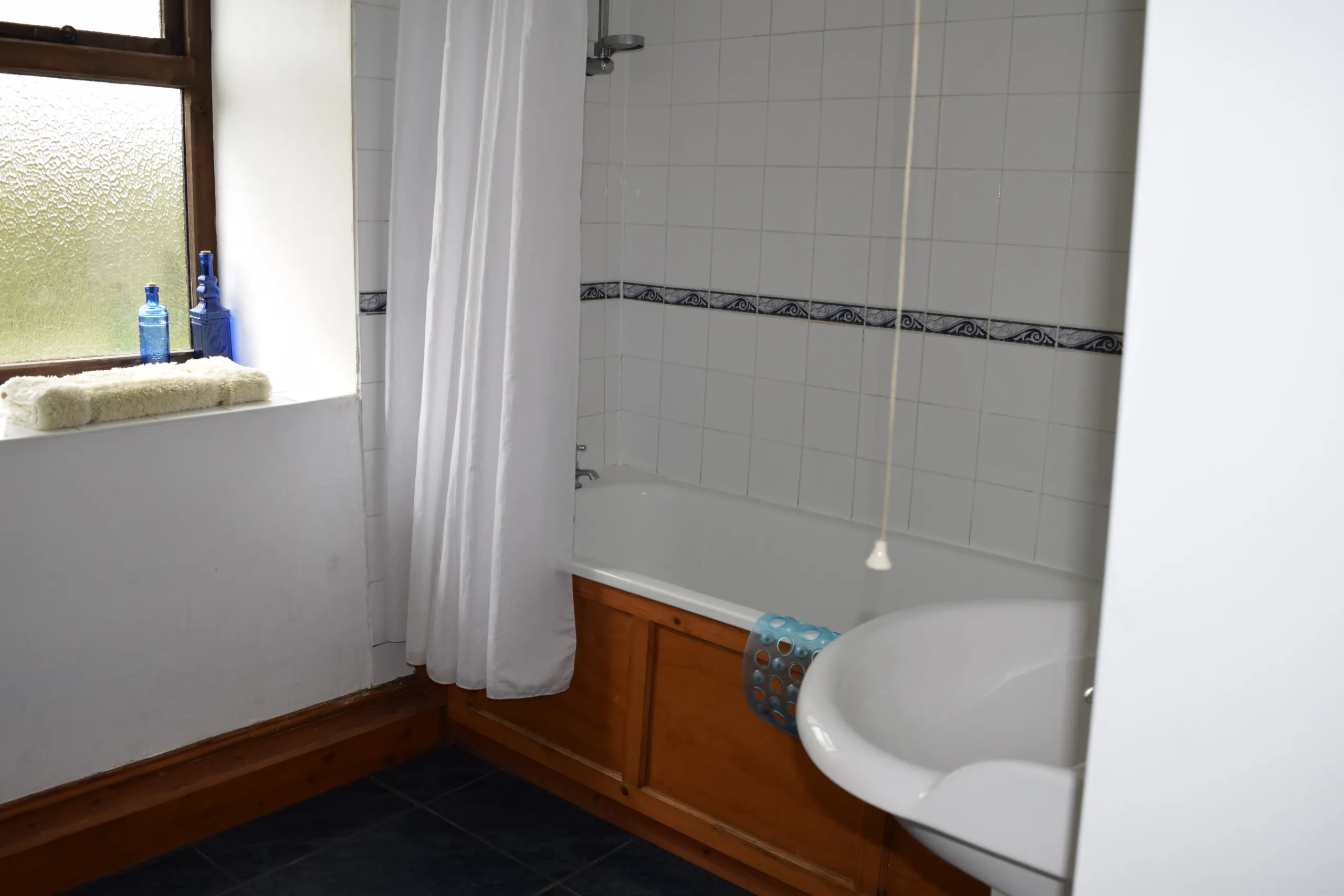 Ground Floor en suite bathroom, bath over shower and wash basin