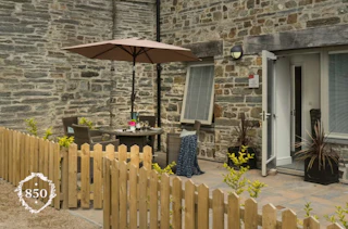 The Coach-house patio with table, four chairs and parasol