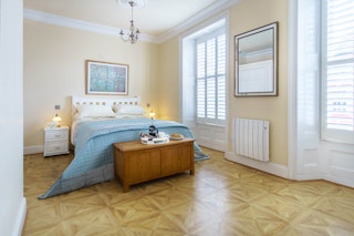 King size bed, bedside cabinets and lamps, blanket box with coffee prepared