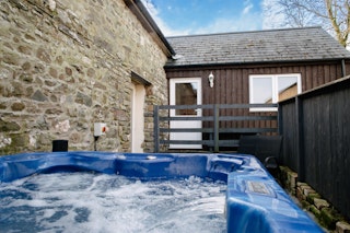 Hot tub with garden chairs alongside
