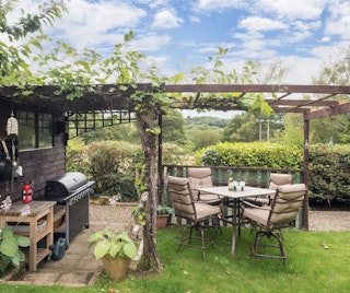 Garden with pergola, outdoor table and chairs, BBQ