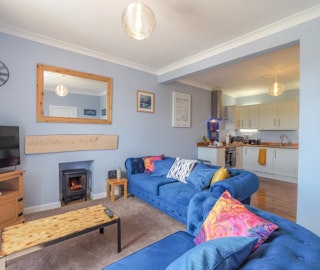 Seabank sitting room with coffee table and carpeted floor
