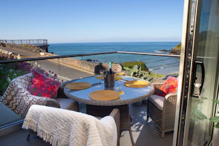 Balcony with table and chairs and amazing sea views