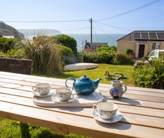 Rear garden with picnic table and sea views