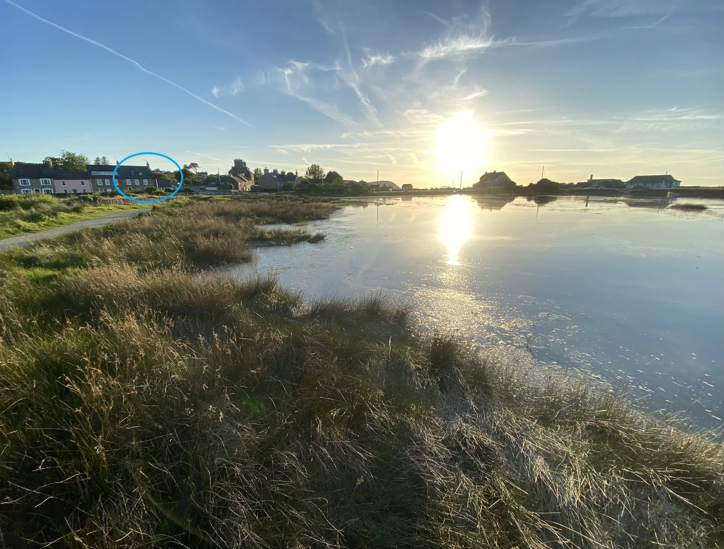 High tide on the estuary with a blue circle marking the location of the cottage