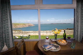 Table and chair with sea view through the window