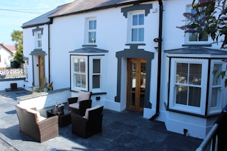 The front of Y Bwthyn Gwyn with outside seats and table