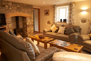 Lounge with sofas, armchair, fireplace, TV