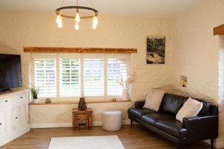 Sitting room with large window with blinds